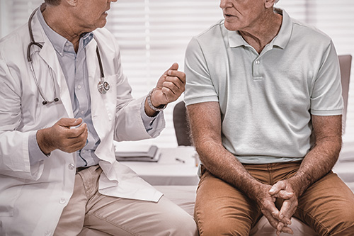 Older man speaking with doctor