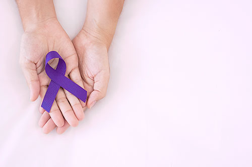 woman holding purple Ribbon for supporting people