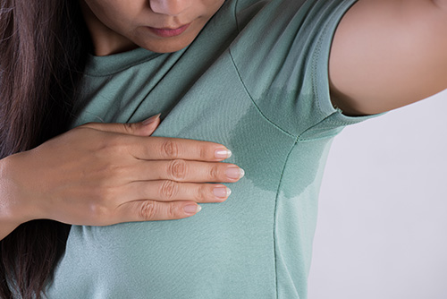 Close-up of woman with hyperhidrosis sweat
